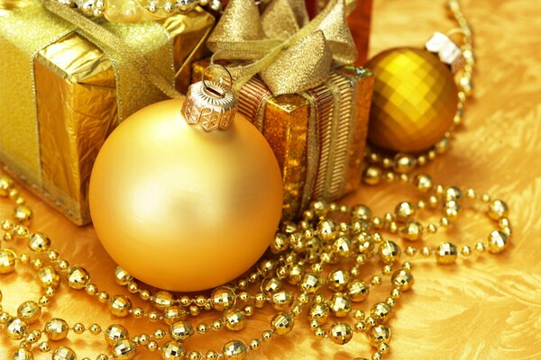 Gold Christmas decorations and a gift with a bow