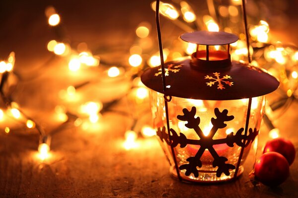 A candle holder with a snowflake and an included garland illumination