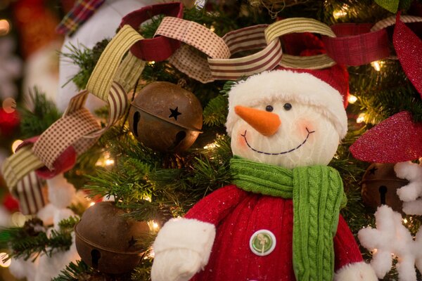 Muñeco de nieve en el árbol de Navidad junto con otras decoraciones