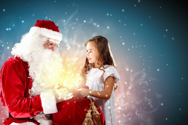 Santa Claus abre una bolsa de regalos para entregar uno de ellos a una niña