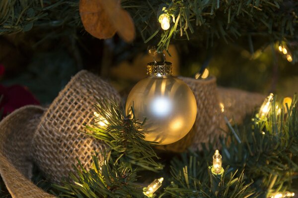 Christmas tree decorated with garlands, balloons and light bulbs