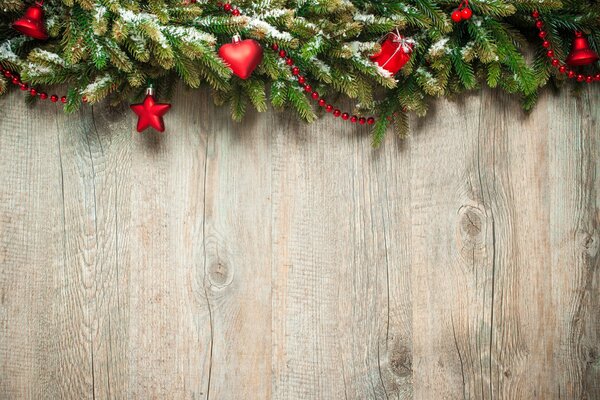 Christmas decorations. Fir branches with red Christmas tree toys