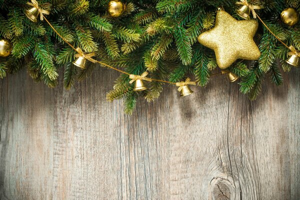 Christmas tree branches decorated for the new year on the plank floor