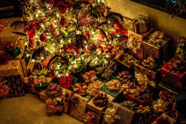 A festive Christmas tree surrounded by New Year s gifts