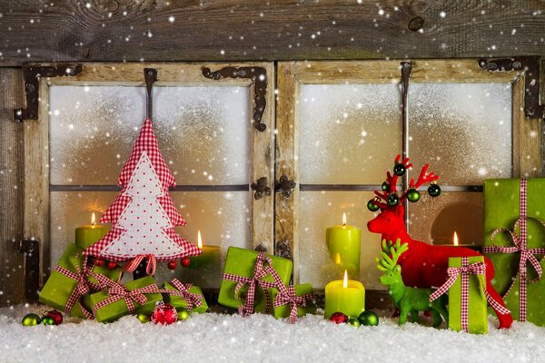 Christmas decorations on the background of a frozen window