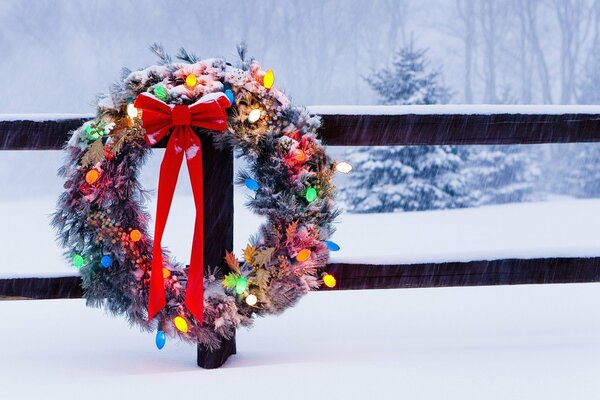 New Year s wreath with garlands on the fence