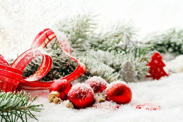 Christmas balls and fir branches in the snow