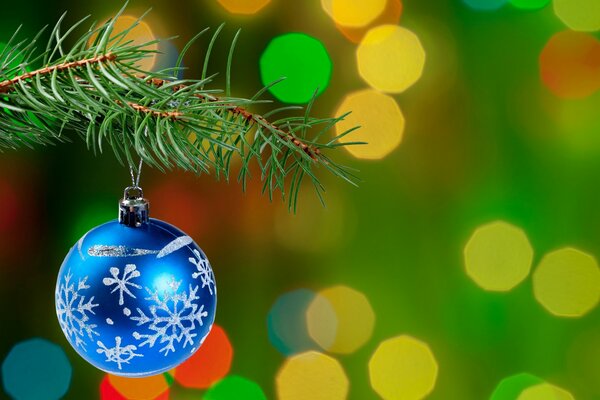 Christmas tree decoration on the branches of the Christmas tree toy ball with snowflakes