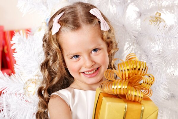 Photo of a child under the Christmas tree. Holiday photo of a girl