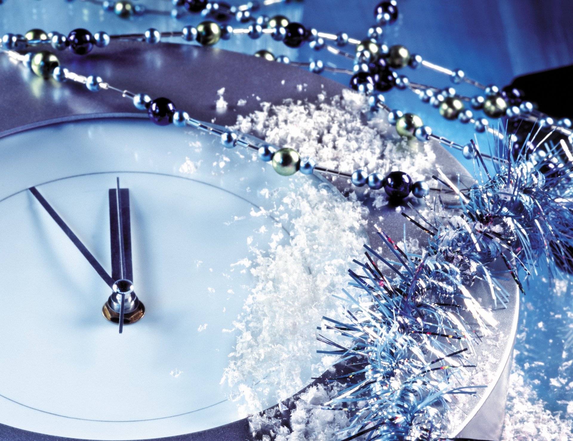 new year situation christmas decoration watches 23:55 five minutes at midnight beads tinsel snow close up