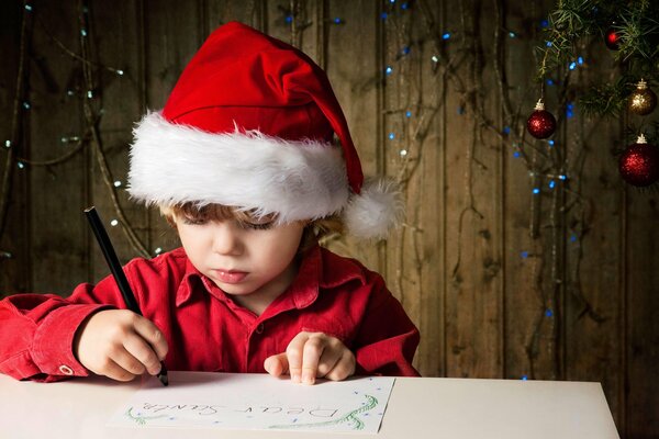 A boy writing a letter to Santa Claus