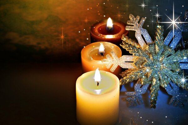 Candles are burning. Snowflake. Winter. Holiday