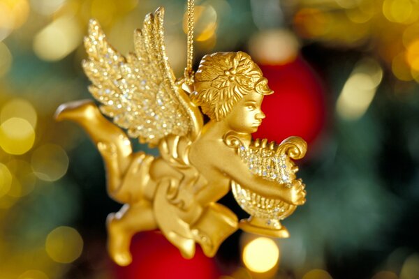 A golden angel with a harp. Christmas Tree toy