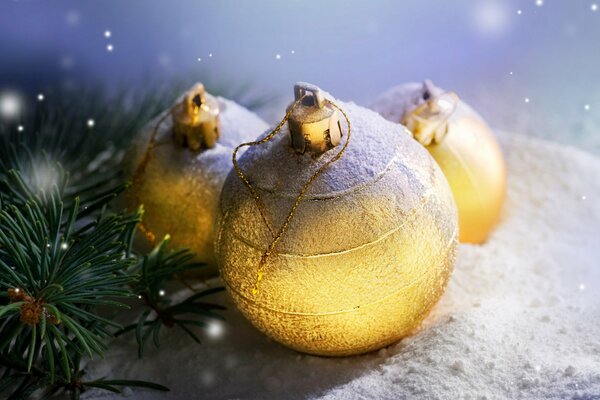 Shiny golden Christmas balls near the Christmas tree