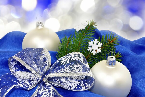 Holiday attributes - Christmas tree, white balls, snowflakes, blue bow