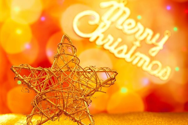 Metal Christmas tree toy-star on the background of the bokeh and the inscription Merry Christmas