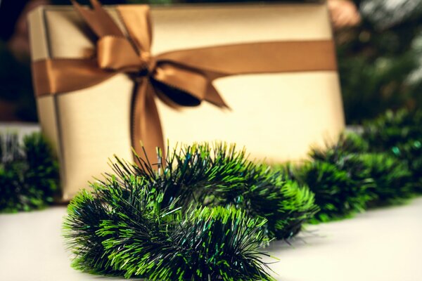 New Year s gift and green tinsel