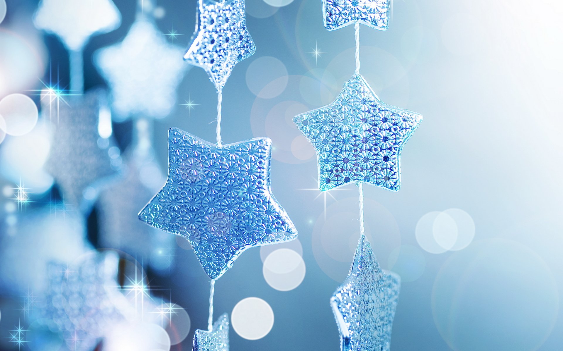 holiday new year garland star blue background shine sequins reflections close up