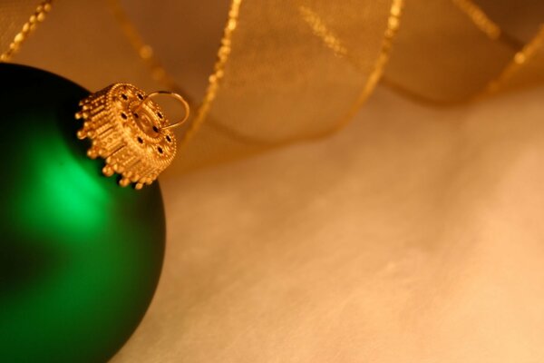 Green toy for the Christmas tree with a gold hanger