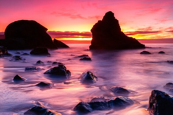 Beautiful sunset on the shore with rocks