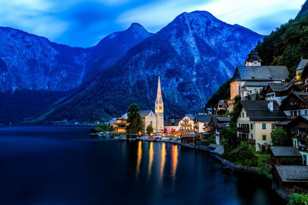 The lake at the foot of the mountains where the houses are located