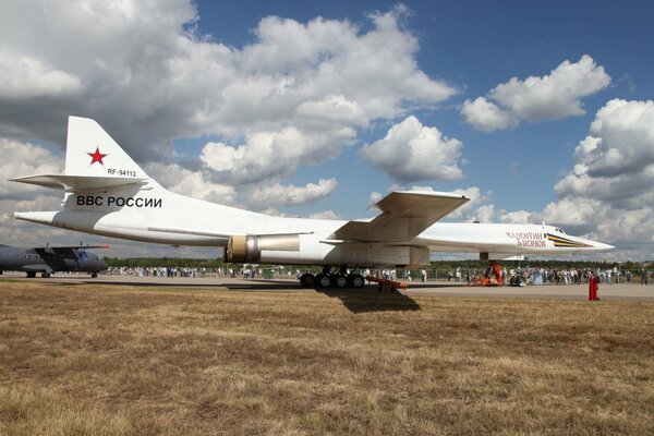 A white Tu-160 bomber. sky, clouds