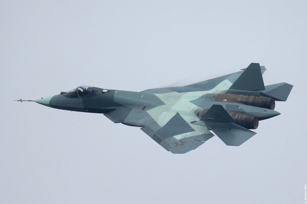 A Russian fighter jet is flying in the sky