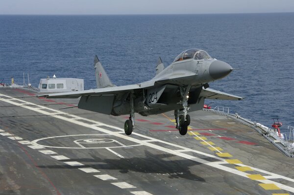 Aircraft carrier landing on a ship in the ocean