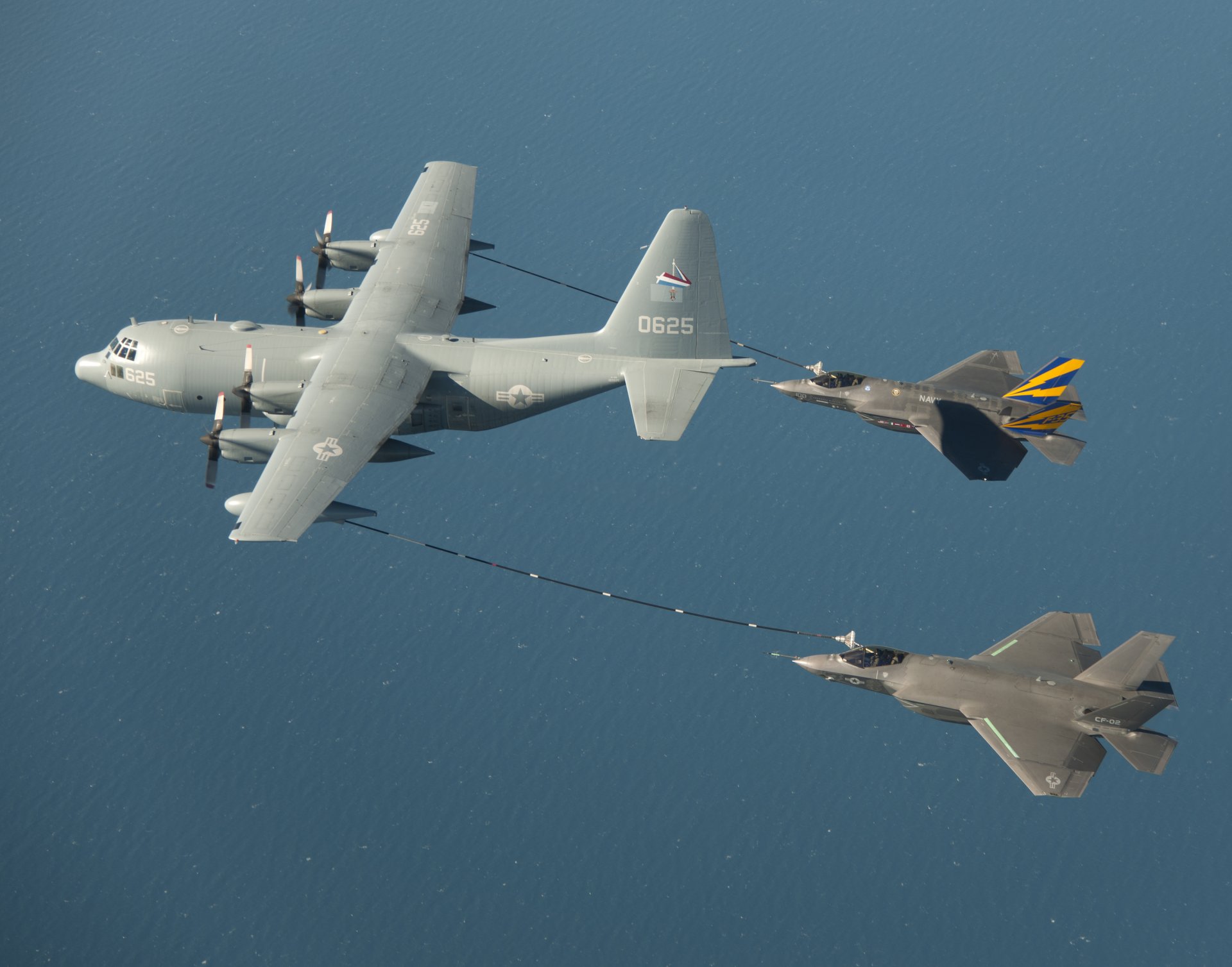 f-35c fighters the pair kc-130 lockheed hercules tanker double refueling in the air ocean