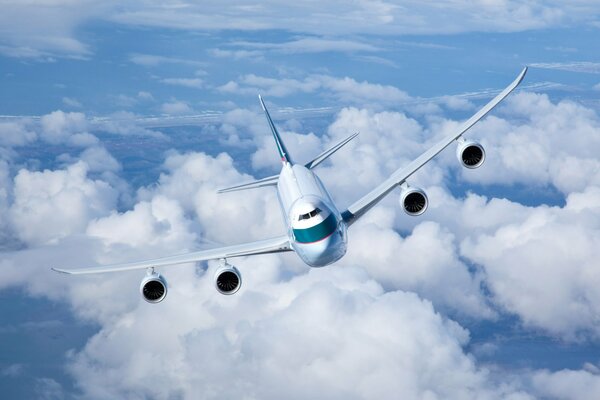 Cargo plane flies against the background of clouds