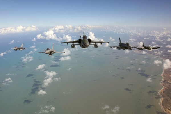 A flight of Dassault Rafale fighters over the coast