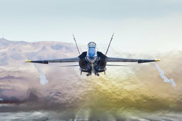 The F / a - 18a hornet flies beautifully low over the ground