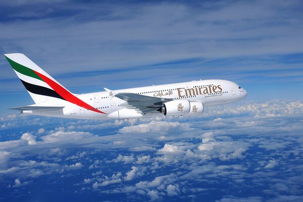 Emirates airbus flies above the clouds