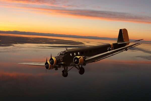 German three-engine Junkers on the background of sunset