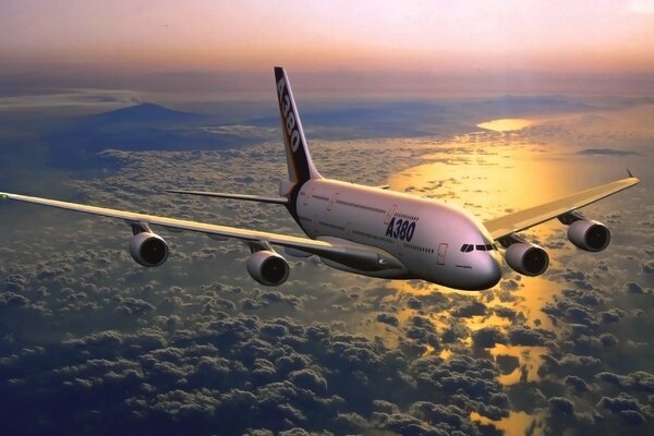 The plane flies over the sea at sunset