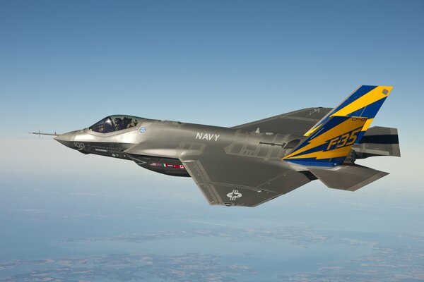 The f-35 fighter is flying at a great height