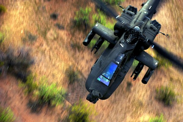 Boeing ah-64 flies over the terrain