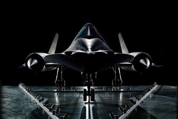 A large plane standing on a highway on a black background