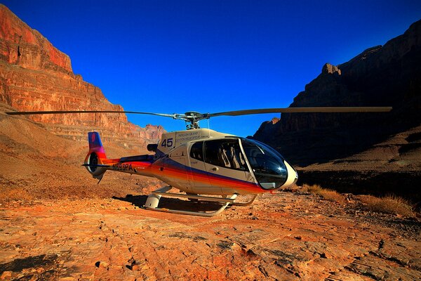 Helicopter in the canyon against the blue sky