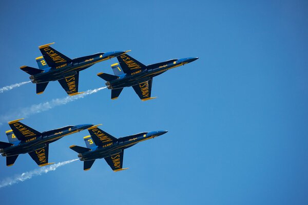 Four military planes flying in the sky