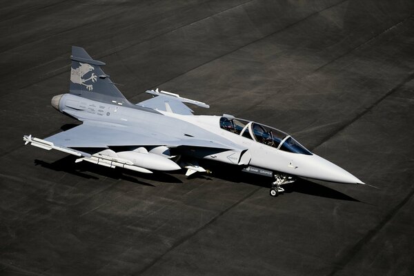 Beautiful military aircraft on black asphalt