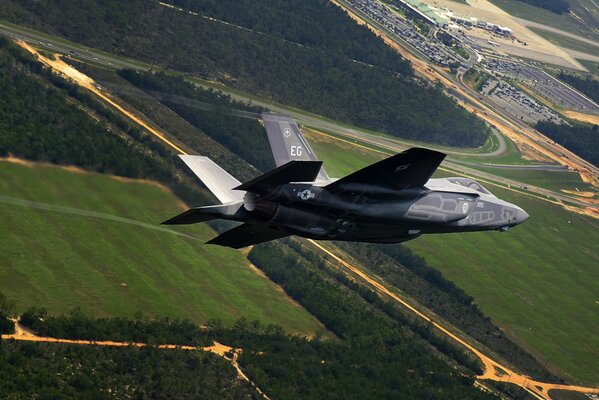 An American fighter jet flies over the field