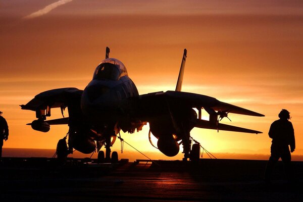 Aircraft carrier over the ocean on the background of sunset