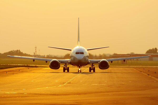 Plane on the runway on a yellow background