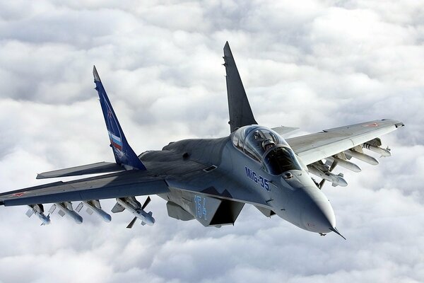 Modern fighter in the sky against the background of clouds