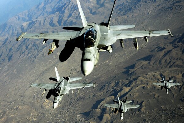 Fighters flying over a mountain range