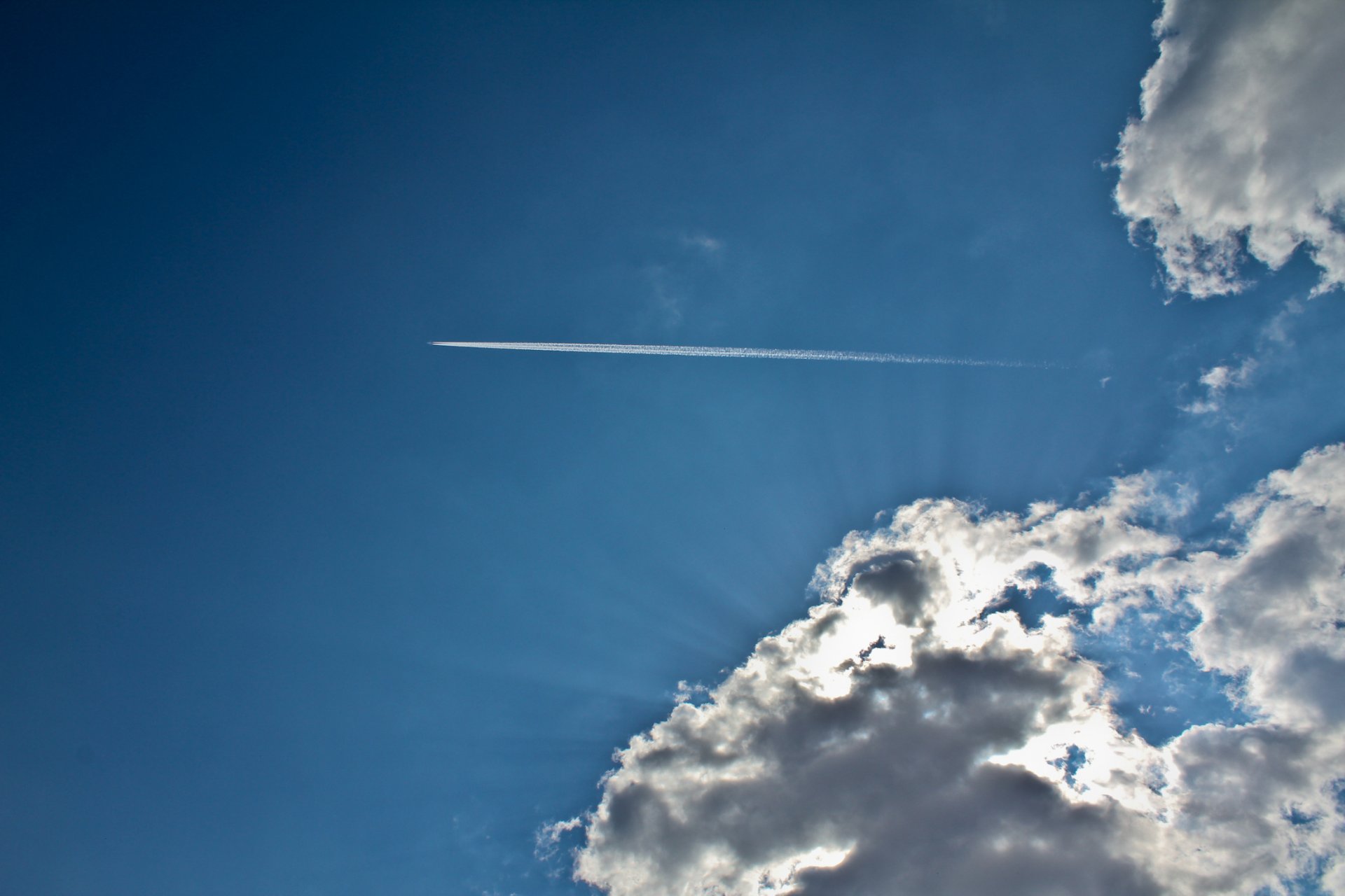 blue sky clouds plane light rays airplane