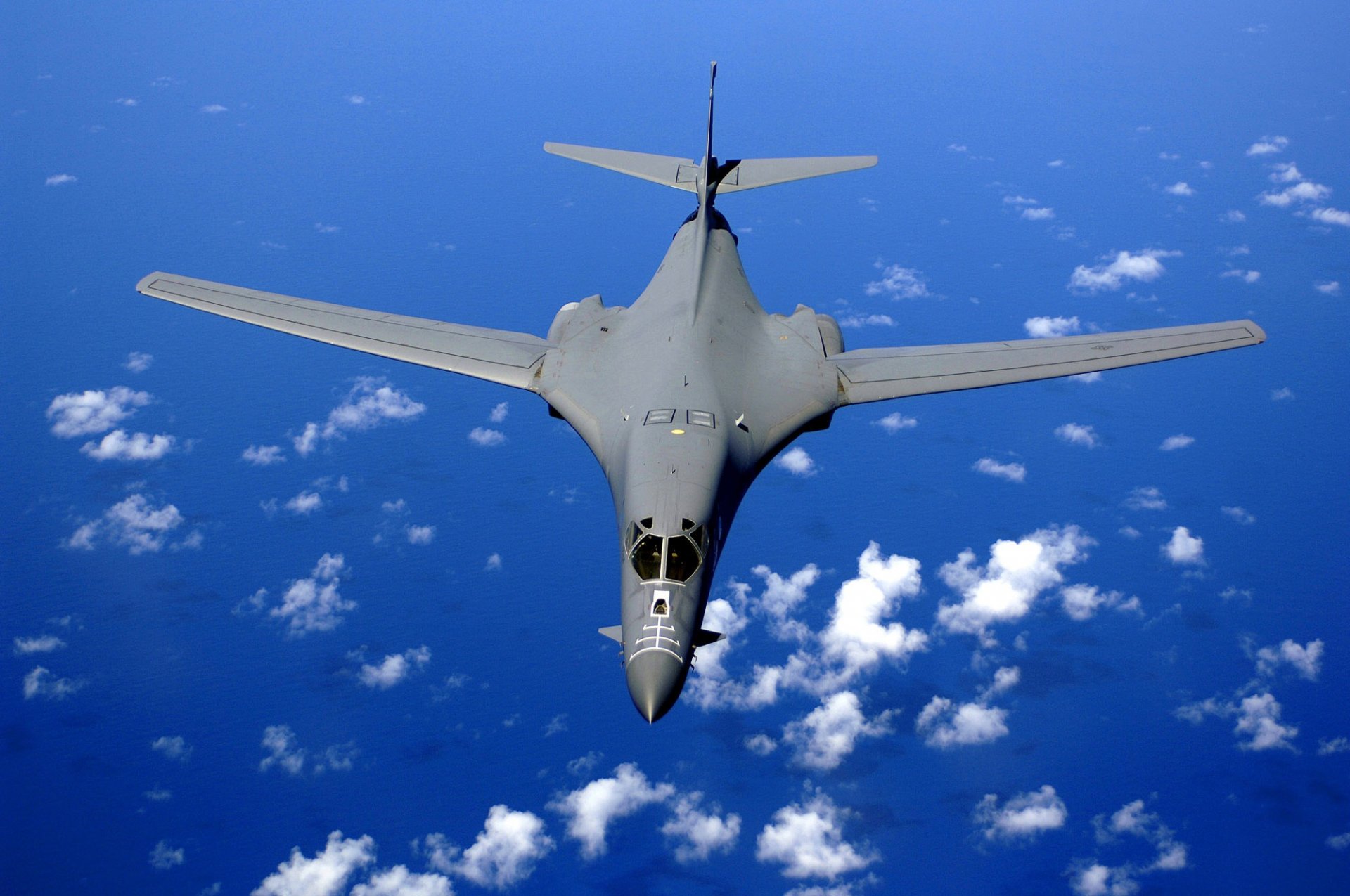 upersonic strategic bomber rockwell b-1 lancer plane flight height clouds sky ocean water