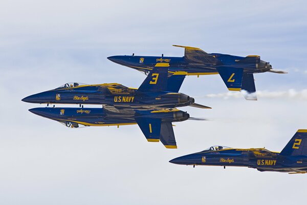 Blue-yellow fighters demonstrate aerobatic skills gathering in the sky in a figure