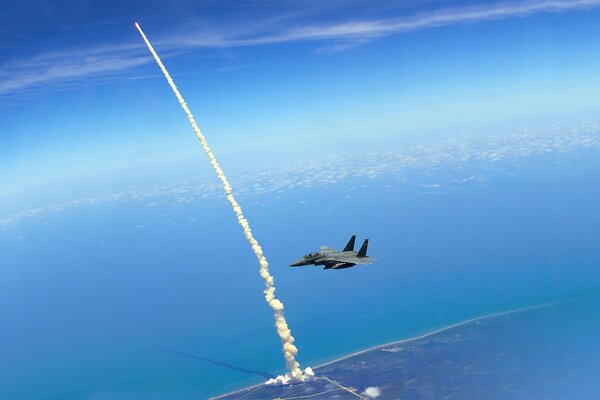 The fighter is flying over the ocean. You can see the launch of the rocket